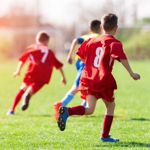 Kids soccer football - children players match on soccer field