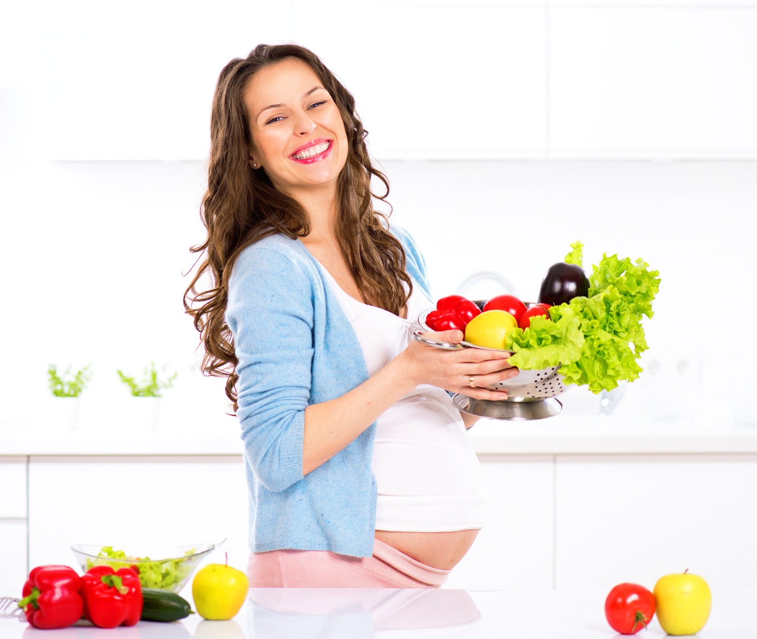 Pregnant young woman cooking vegetables. Healthy food